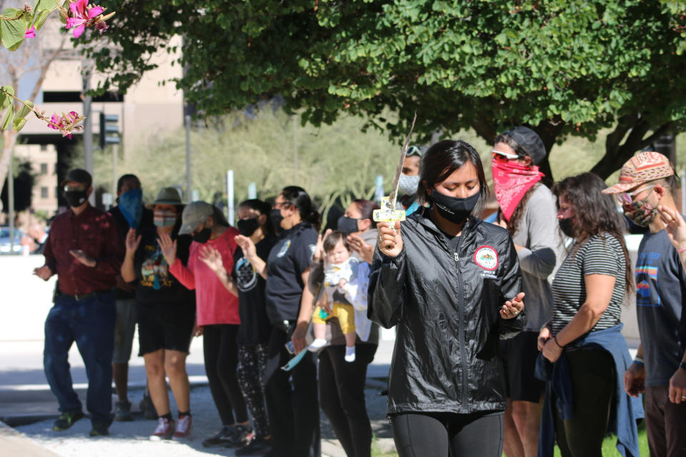 Naelyn Pike, who is Chiricahua Apache, leads a prayer outside the federal courthouse in Phoenix, Tuesday, Feb. 2, 2021. She's part of the group Apache Stronghold that is asking a federal judge to keep the U.S. Forest Service from turning over a parcel of land that Apaches consider sacred to a copper mining company. (AP Photo/Cheyanne Mumphrey)