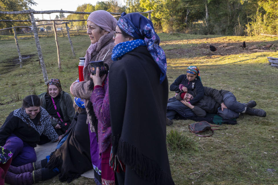 Community members prepare to share a meal in the culmination of the multiday celebration of We Tripantu, the Mapuche new year, in Carimallin, southern Chile, on Sunday, June 26, 2022. (AP Photo/Rodrigo Abd)