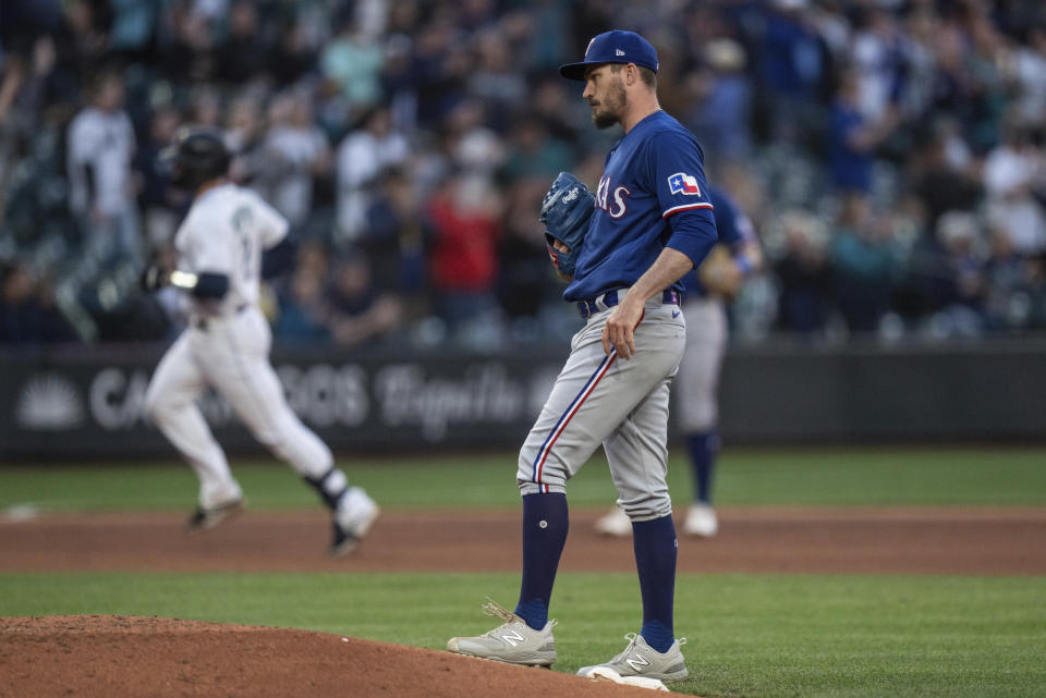 Texas Rangers starting pitcher Andrew Heaney waits after giving up a two-run home run to Seattle Mariners' Tom Murphy during the seventh inning of a baseball game Tuesday, May 9, 2023, in Seattle. (AP Photo/Stephen Brashear)