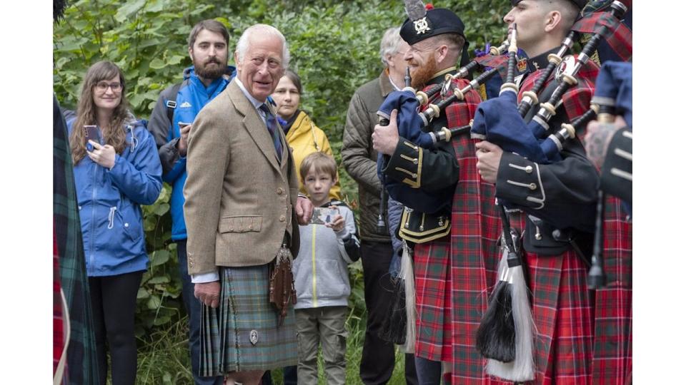 King Charles III meets members of the Band of The Royal Regiment of Scotland and the Pipes and Drums of the Royal Corps of Signals