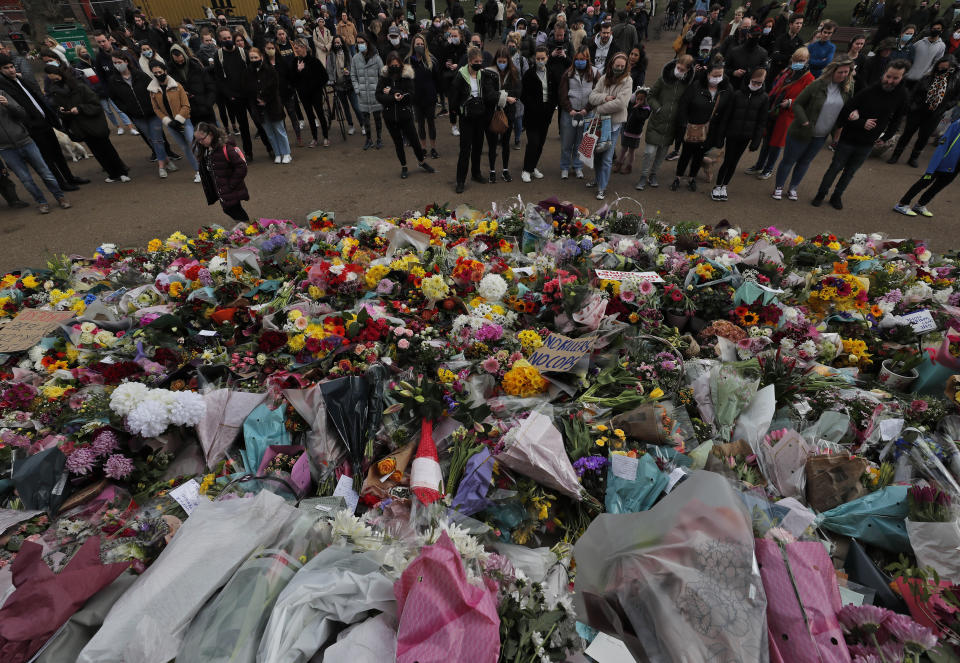 Floral tributes are placed at the bandstand in Clapham Common in London, Sunday, March 14, 2021 in memory of Sarah Everard who was abducted and murdered after last being seen walking home from a friend's apartment in south London on the night of March 3. London’s Metropolitan Police was under heavy pressure Sunday to explain its actions during a vigil for a woman whom one of the force's own officers is accused of murdering. Hundreds defied coronavirus restrictions to gather and protest violence against women, but the event ended with clashes between police and those attending. (AP Photo/Frank Augstein)