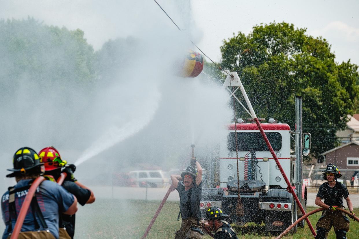 Firefighters from Erie Valley Fire & Rescue in Navarre compete in the water-barrel battle during the fourth annual HRN Firefighter Field Day, Saturday, June 10 at the Tuscarawas County Fairgrounds in Dover. Proceeds from the event went to benefit the Akron Children’s Hospital Burn Camp program.