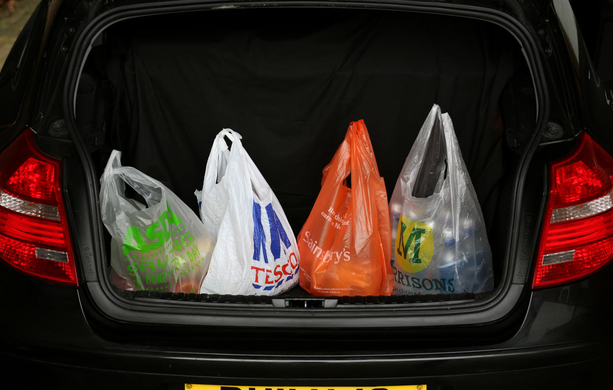 Asda, Tesco, Sainsbury's and Morrisons shopping bags in a car boot. Photo: Chris Radburn/PA Archive/PA Images