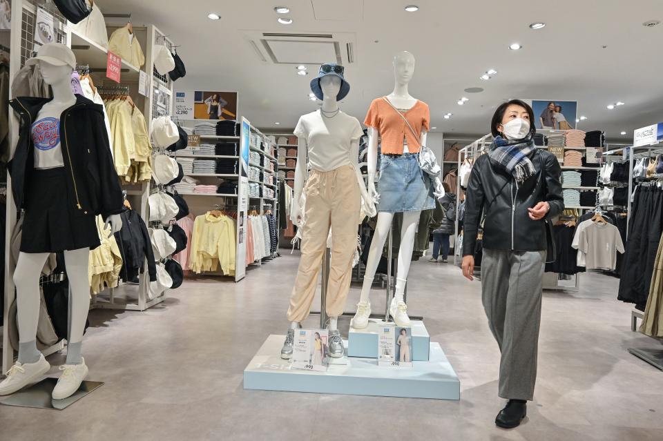 This photo taken on March 7, 2024 shows a woman walking inside a GU clothing store, a sister brand of Fast Retailing clothing brand UNIQLO, in the Ginza district of downtown Tokyo. (Photo by Richard A. Brooks / AFP) (Photo by RICHARD A. BROOKS/AFP via Getty Images)