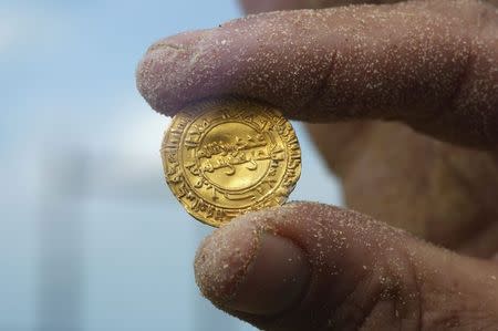 An ancient gold coin is displayed in Caesarea, north of Tel Aviv along the Mediterranean coast February 18, 2015. REUTERS/Nir Elias
