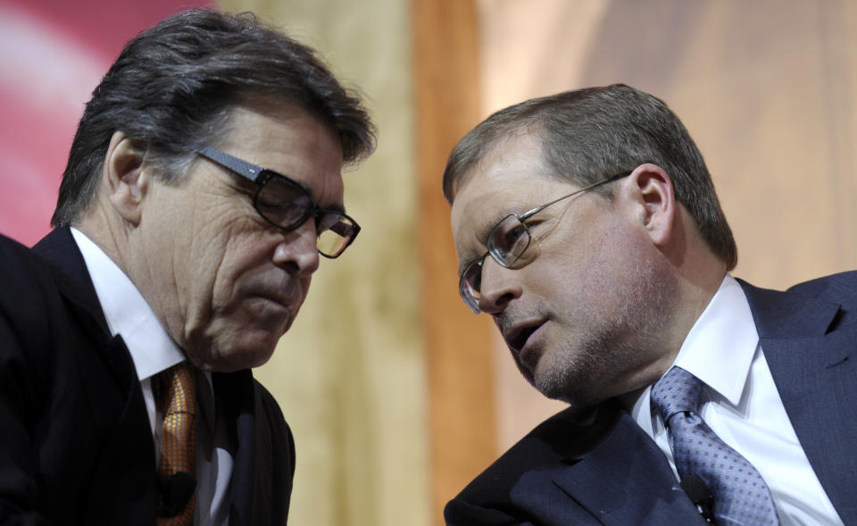 FILE - In this March 7, 2014 file photo Texas Gov. Rick Perry, left, talks with Americans for Tax Reform President Grover Norquist, right, before participating on a panel discussion at the Conservative Political Action Committee annual conference in National Harbor, Md. Perry has spent a record 14 years in office, but with eight months left he is now the focus of a grand jury investigation over a veto last summer. (AP Photo/Susan Walsh, File)