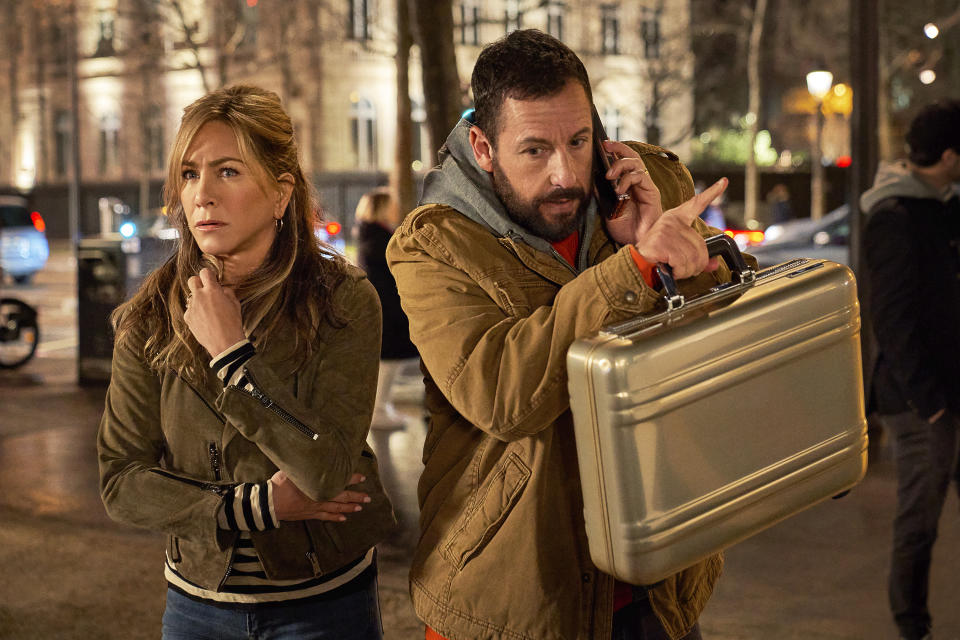 This image released by Netflix shows Jennifer Aniston, left, and Adam Sandler in a scene from the film "Murder Mystery 2." (Scott Yamano/Netflix via AP)