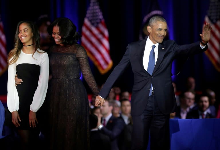 US President Barack Obama paid tribute to First Lady Michelle Obama (C) and addressed his daughters, praising the "two amazing young women" they had become