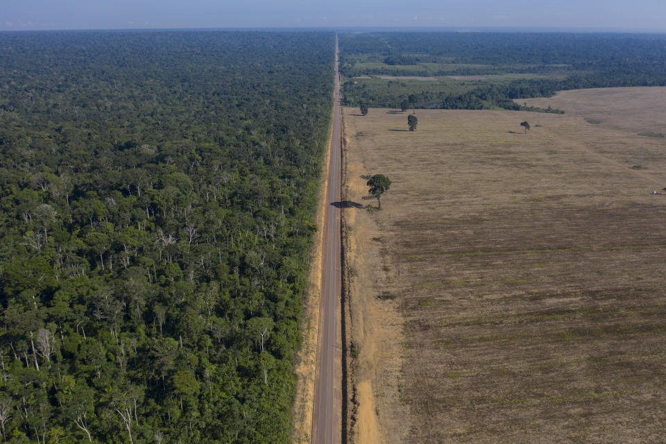 FILE - In this Nov. 25, 2019 file photo, highway BR-163 stretches between the Tapajos National Forest, left, and a soy field in Belterra, Para state, Brazil. Preliminary data released on June 4, 2021, signaled deforestation of Brazil’s Amazon in May 2021 extended this year's surge compared to 2020. (AP Photo/Leo Correa, File)