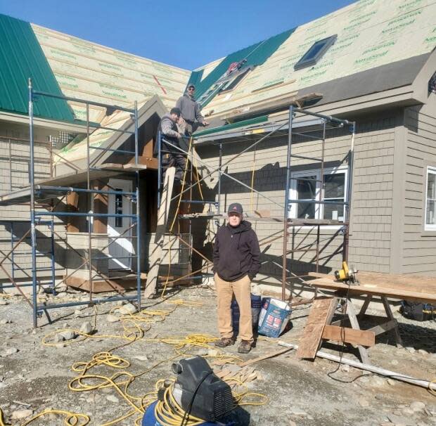 Iain Cocks stands in front of a home his crew is currently building in Port Joli, Queens County. Most lumber is now double or triple the price it was before the COVID-19 pandemic. (Eric Jardine - image credit)