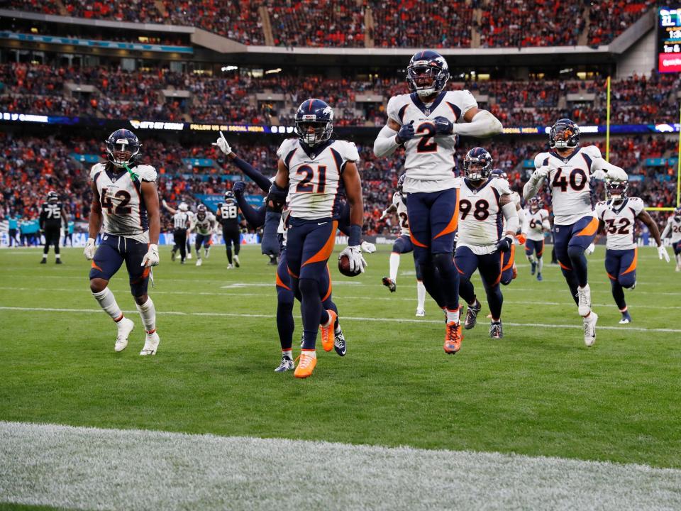 The Denver Broncos defense celebrates an interception.