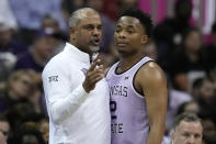 Kansas State head coach Jerome Tang talks to guard Tylor Perry (2) during the first half of an NCAA college basketball game against Texas Wednesday, March 13, 2024, in Kansas City, Mo. (AP Photo/Charlie Riedel)