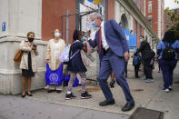 New York Mayor Bill de Blasio, center right, greets students as they arrive for in-person classes outside Public School 188 The Island School, Tuesday, Sept. 29, 2020, in the Manhattan borough of New York. Hundreds of thousands of elementary school students are heading back to classrooms starting Tuesday as New York City enters a high-stakes phase of resuming in-person learning during the coronavirus pandemic. (AP Photo/John Minchillo)