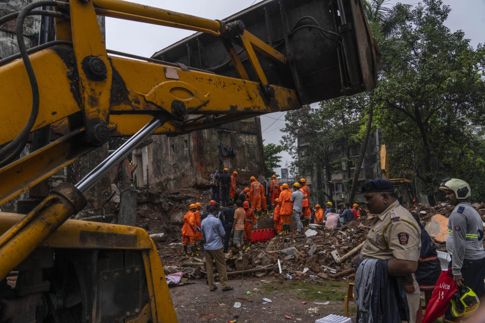 Rescuers work at the site of a four-story residential building that collapsed in Mumbai, India, Tuesday, June 28, 2022. At least three people died and more were injured after the building collapsed late Monday night. (AP Photo/Rafiq Maqbool)