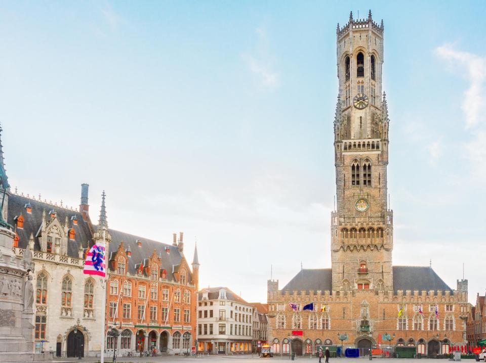 Bruges' ancient tower overlooking the market square - ISTOCK