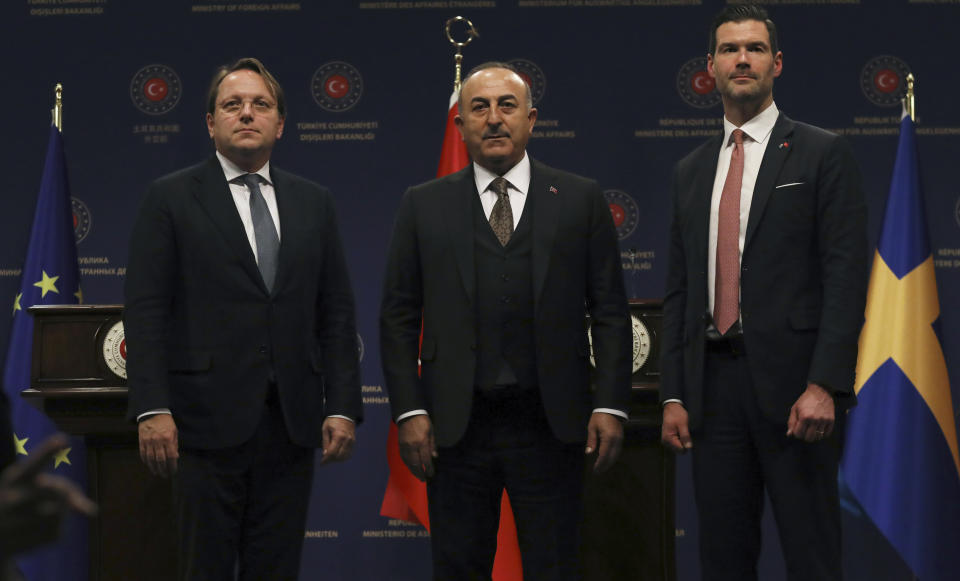 Turkey's Foreign Minister Mevlut Cavusoglu, centre, European Commissioner for Neighbourhood and Enlargement Oliver Varhelyi, left, and Sweden's Minister for International Development Cooperation and Foreign Trade Johan Forssell stand at the end of a joint news conference in Ankara, Turkey, Wednesday, Feb. 22, 2023. Varhelyi and Forssell are in town to prepare for the International Donor's Conference, scheduled for March in Brussels, and aimed at mobilizing funds from the international community to support Turkey and Syria following the quakes.(AP Photo/Burhan Ozbilici)