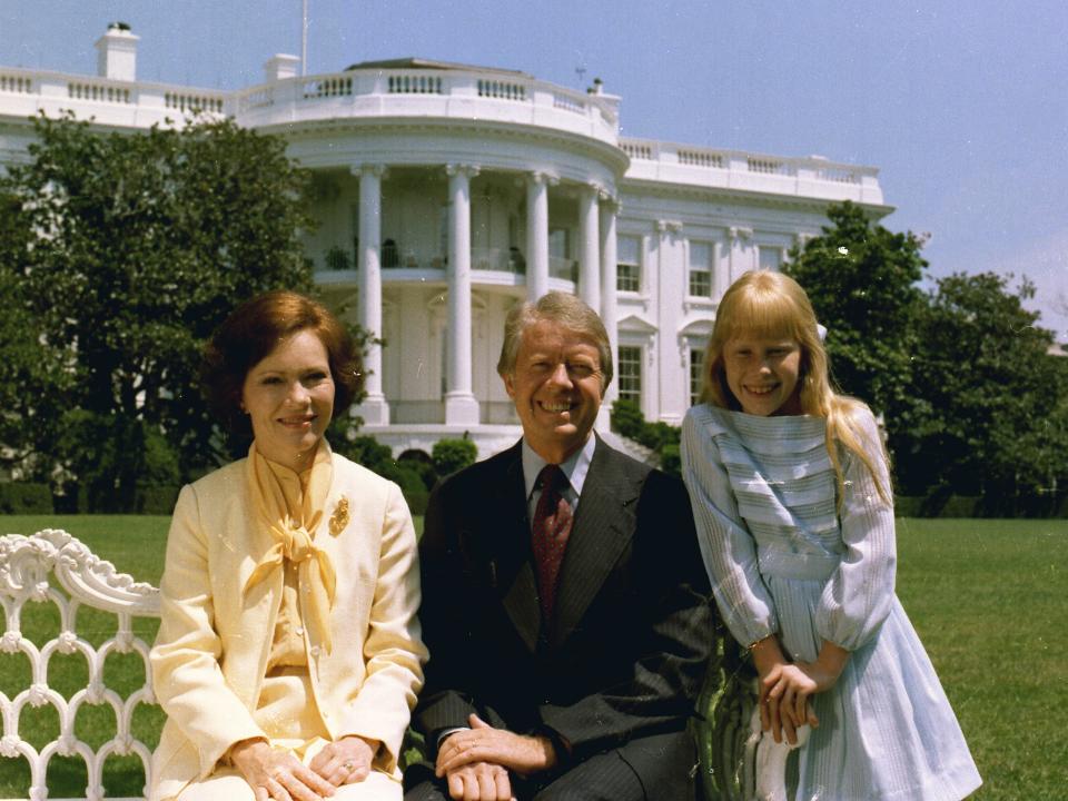 Rosalynn Carter, Jimmy Carter, and Amy Carter with the White House in the background