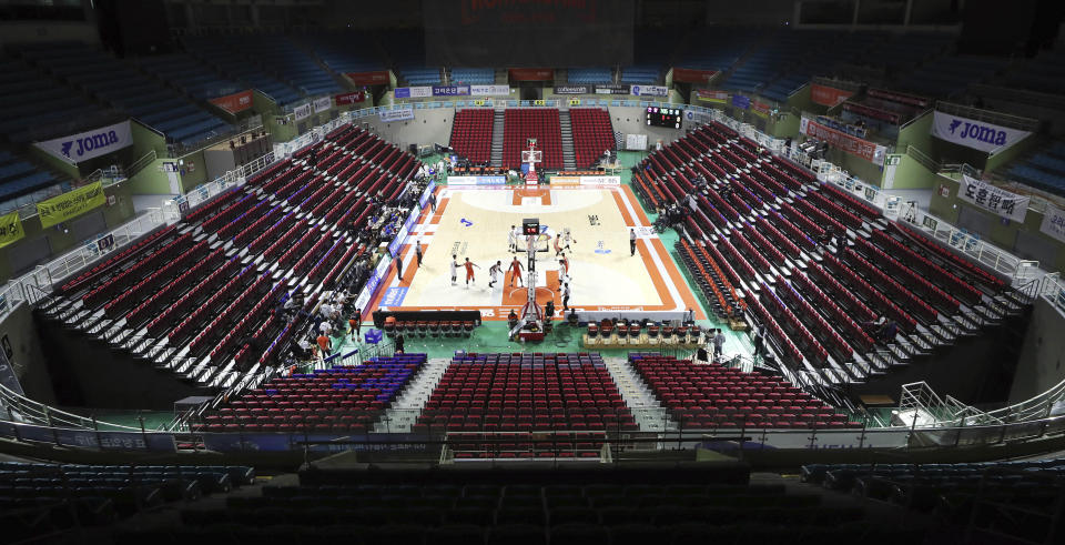 The stadium's seats are empty during the Korean Basketball League between Incheon Electroland Elephants and Anyang KGC clubs in Incheon, South Korea, Wednesday, Feb. 26, 2020. The basketball game held without spectators as a precaution against the COVID-19. (Yun Tai-hyun/Yonhap via AP)
