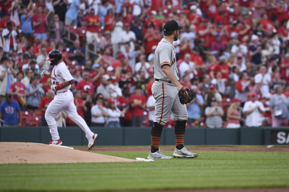 San Francisco Giants starting pitcher Carlos Rodon, right, looks on as St. Louis Cardinals' Paul Goldschmidt rounds the bases after hitting a two run home run during the first inning of a baseball game on Sunday, May 15, 2022, in St. Louis. (AP Photo/Joe Puetz)