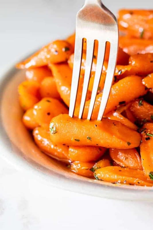 <p>Grandbaby Cakes</p><p>This Honey Glazed Carrots recipe is fuss-free, nutrient dense and made in less than 20 minutes! Coated with a honey, brown sugar and orange juice sweetened glaze, these carrots are anything but ordinary.</p><p><strong>Get the recipe: <a href="https://grandbaby-cakes.com/honey-glazed-carrots/" rel="nofollow noopener" target="_blank" data-ylk="slk:Honey Glazed Carrots;elm:context_link;itc:0;sec:content-canvas" class="link ">Honey Glazed Carrots</a></strong></p>