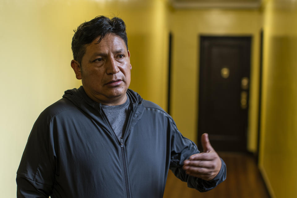 Ecuadorian immigrant Neptali Chiluisa speaks during an interview inside his temporary home he shares with other Ecuadorian families in the borough of Bronx on Thursday, Oct. 21, 2021, in New York. Chiluisa crossed the border in June in Arizona and was detained for a week with his 14-year-old son, leaving behind his wife and three other children in Ecuador. He was a boiler specialist for the army and found a similar job at New York construction sites. (AP Photo/Eduardo Munoz Alvarez)