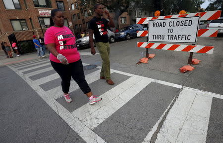 Mothers Against Senseless Killings (MASK) member Kim Dunbar and Marquinn McDonald patrol the Englewood neighborhood in Chicago, Illinois, United States, August 5, 2015. REUTERS/Jim Young