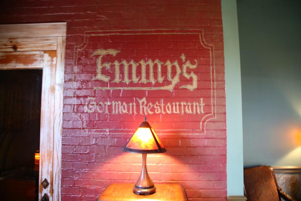 A painted "Emmy's German Restaurant" on one of the walls of Taliano's Italian Restaurant greets customers as they walk in.