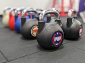 <p>A picture from the Pixel 6a's camera, featuring two rows of colorful kettlebells with the background blurred.</p> 