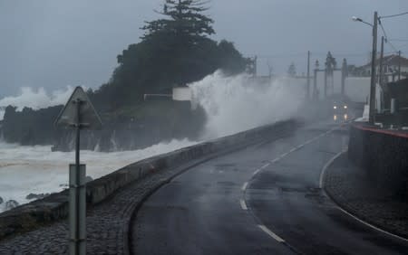 Waves crash on a wall near Angra do Heroismo in Azores