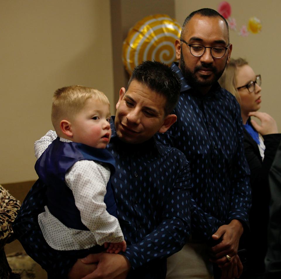 The Casados family wait in line for pictures on Nov. 18 at Lubbock Impact after their final adoption hearing. Isaiah, center and Joaquin Casados have been foster parents for four years and adopted their first child.
