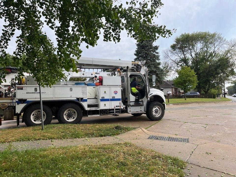 Crews work on power lines on Hubbell Avenue in Des Moines on Aug. 19, 2022.