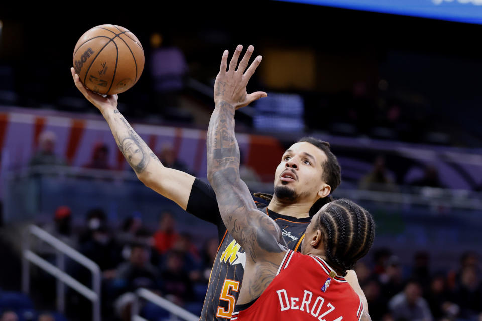 Orlando Magic guard Cole Anthony (50) shoots under pressure from Chicago Bulls forward DeMar DeRozan (11) in the first half of an NBA basketball game, Sunday, Jan. 23, 2022, in Orlando, Fla. (AP Photo/Joe Skipper)