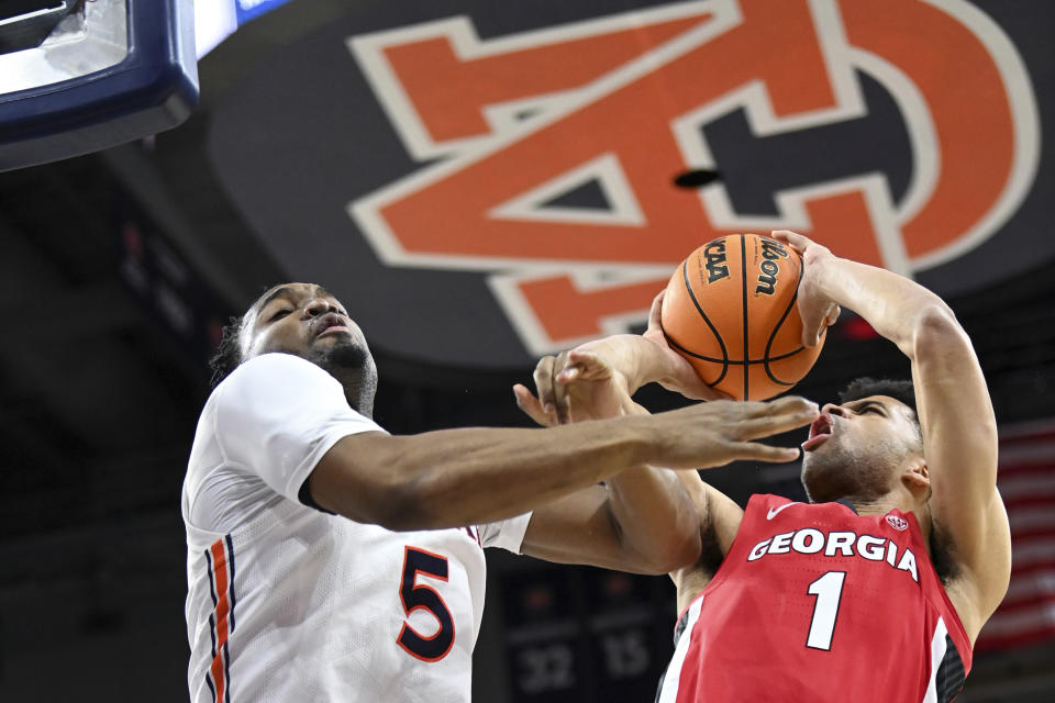 Auburn forward Chris Moore (5) defends a shot during the first half of an NCAA college basketball game, Wednesday, Feb. 1, 2023, in Auburn, Ala. (AP Photo/Julie Bennett)