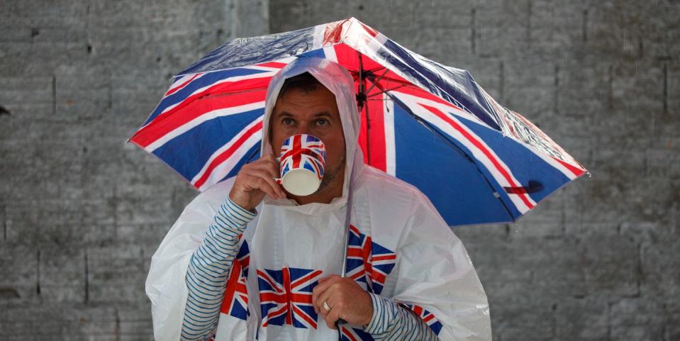 patriotic british man drinking tea during wet weather