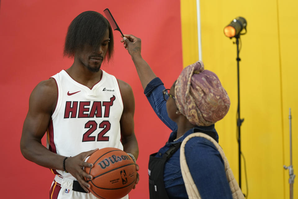 Miami Heat forward Jimmy Butler (22) gets his new hairdo brushed ahead of a portrait shoot, during the NBA basketball team's media day, in Miami, Monday, Oct. 2, 2023. (AP Photo/Rebecca Blackwell)