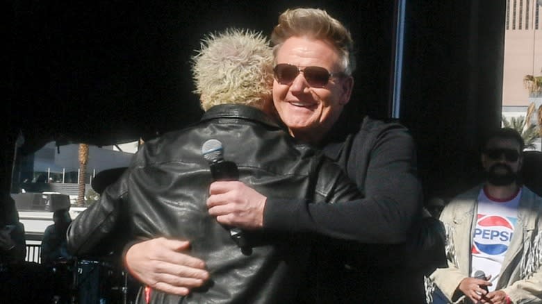 Guy Fieri and Gordon Ramsay hugging at Fieri's 2024 tailgate