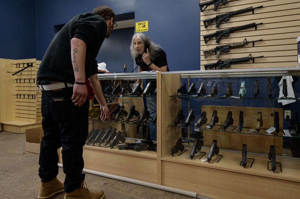 A customer browses guns for sale at RTD Arms & Sport in Goffstown, N.H., on June 2. 