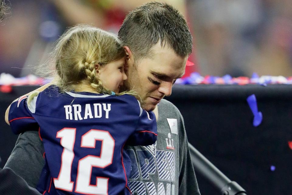 Tom Brady #12 of the New England Patriots celebrates with his daughter Vivian after defeating the Atlanta Falcons 34-28