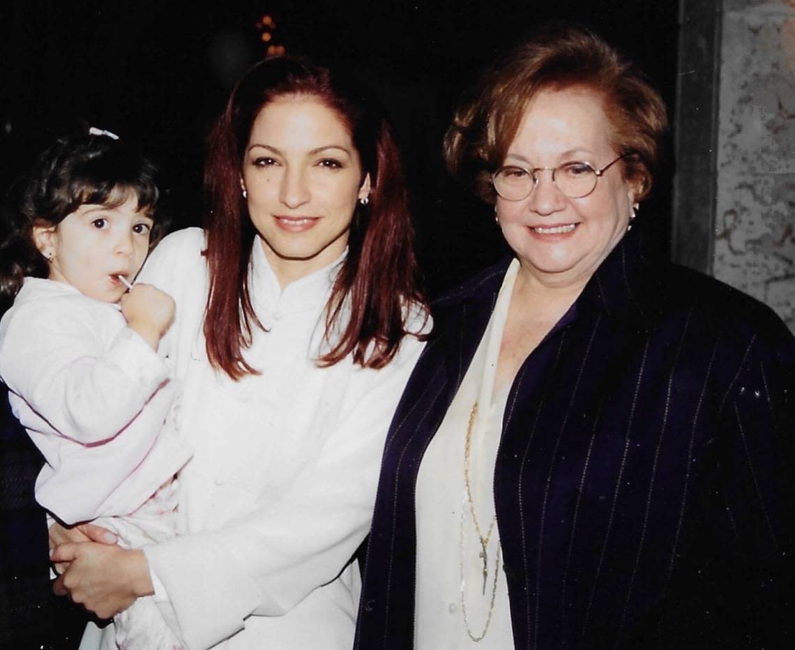 Emily Estefan, when she was little and in her mother Gloria Estefan’s arms and Gloria’s mother, Gloria Fajardo, in a family album photo of three generations of Estefan women.