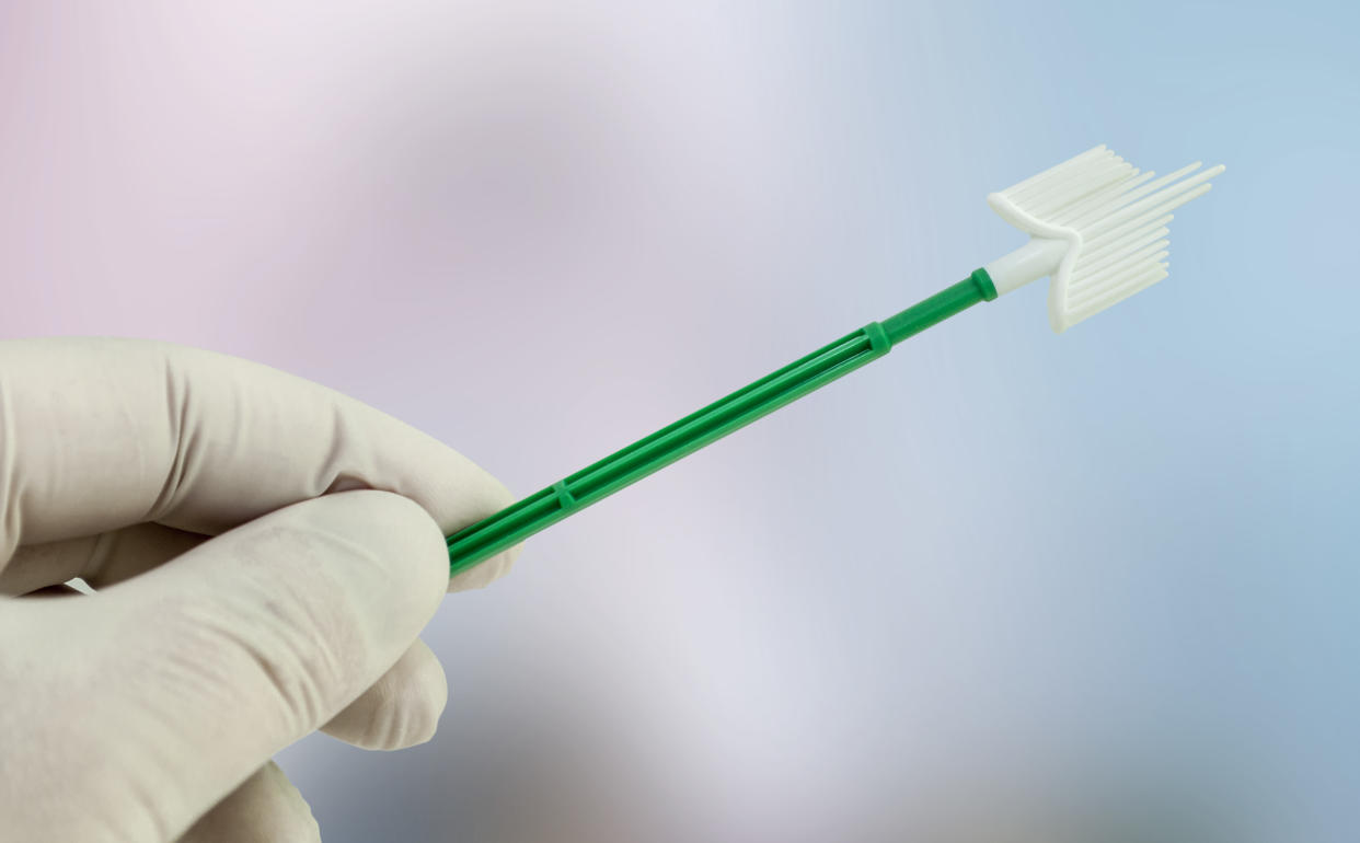 Gynecologist hand with latex glove with gynecological swab to take samples for cytologyto to prevent the cancer of papillomavirus