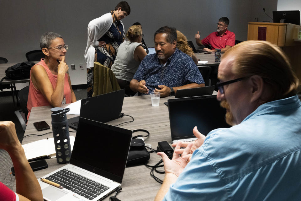 Dr. Stephanie Laggini Fiore, Associate Vice Provost and Sr. Director of the Center for the Advancement of Teaching, back, hosts a faculty teaching circle on artificial intelligence on Wednesday, Aug. 9, 2023, at Temple University in Philadelphia. Educators say they want to embrace the technology’s potential to teach and learn in new ways, but when it comes to assessing students, they see a need to “ChatGPT-proof” test questions and assignments. (AP Photo/Joe Lamberti)