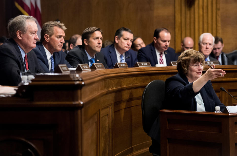 Rachel Mitchell, counsel for Senate Judiciary Committee Republicans, questions Christine Blasey Ford as Republican senators Mike Crapo, Jeff Flake, Ben Sasse, Ted Cruz, Mike Lee and John Cornyn listen during the Senate Judiciary Committee hearing.