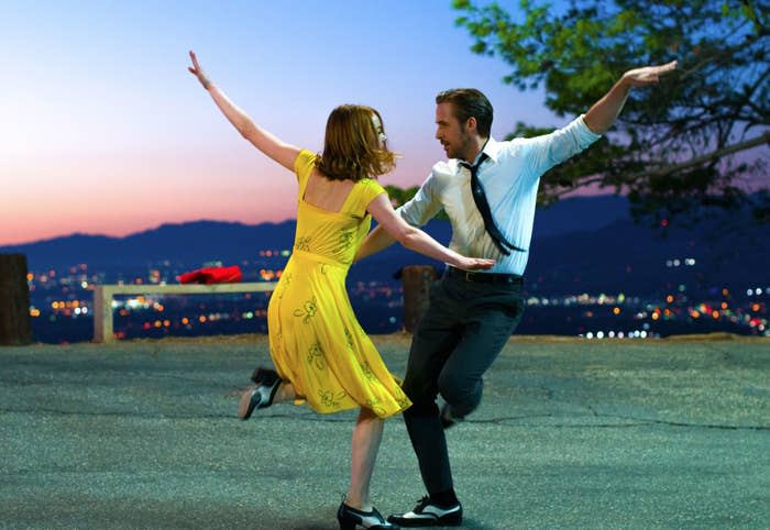Emma Stone and Ryan Gosling dancing outdoors in 'La La Land', she in a yellow dress and he in a white shirt and black pants