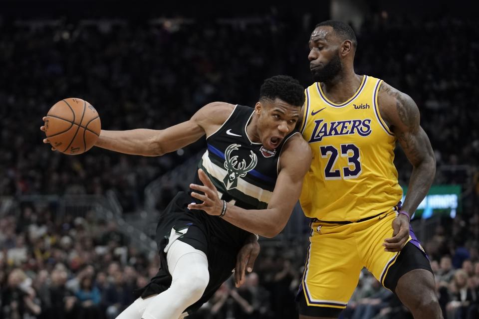 Milwaukee Bucks' Giannis Antetokounmpo tries to drive past Los Angeles Lakers' LeBron James during the second half of an NBA basketball game Thursday, Dec. 19, 2019, in Milwaukee. The Bucks won 111-104. (AP Photo/Morry Gash)