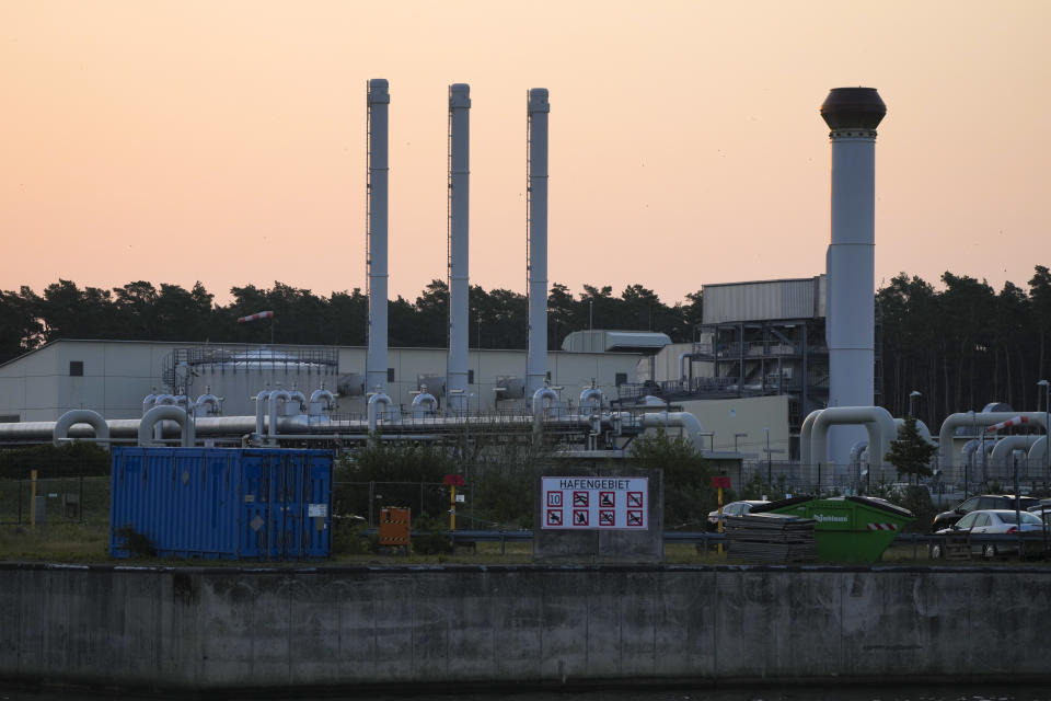 The sun rises behind the landfall facility of the Nord Stream 1 Baltic Sea pipeline and the transfer station of the OPAL gas pipeline, the Baltic Sea Pipeline Link, in Lubmin, Germany, Thursday, July 21, 2022. (AP Photo/Markus Schreiber)