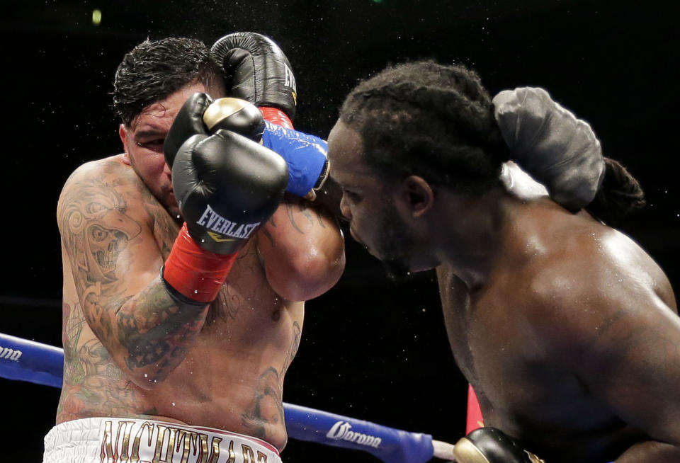 Bermane Stiverne, right, hits Chris Arreola during their rematch for the WBC heavyweight boxing title in Los Angeles, Saturday, May 10, 2014. Stiverne won the title. (AP Photo/Chris Carlson)