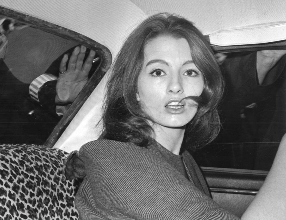 FILE - In this July 22, 1963 file photo, Christine Keeler is photographed during a vice charges case against osteopath Dr. Stephen Ward. The model had been having an affair with Cabinet member John Profumo at the same time as having a liaison with a Russian naval attache. The scandal rocked the political establishment. It was one of the great postwar crises in Britain, the latest of which relates to the country's struggles to leave the European Union. (AP Photo/File)