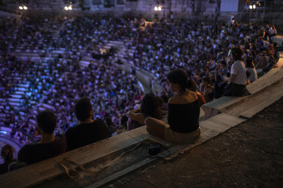 Spectators listen a concert at the Odeon of Herodes Atticus in Athens, on Wednesday, July 15, 2020. The ancient theaters of Herodes Atticus in Athens and Epidaurus in the southern Peloponnese area have reopened for performances with strict seating limits and public health safety guidelines. (AP Photo/Petros Giannakouris)