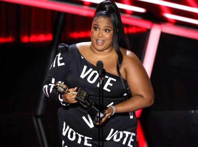 Lizzo posed in a daring American flag jumpsuit that was cut in half to  represent the percentage of people who didn't vote in 2016