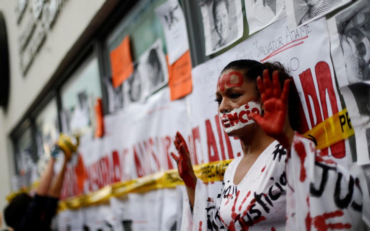 An activist takes part during a demonstration against the murder of journalists in Mexico - REUTERS